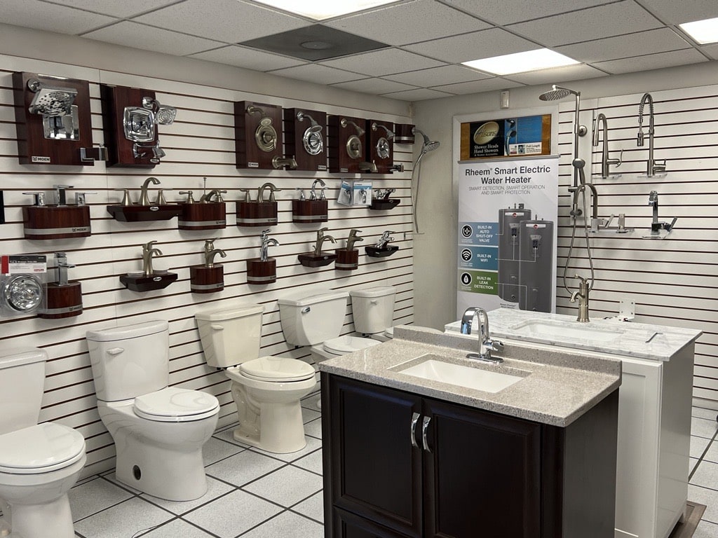 A retail space showcase of various bathroom fixtures including sinks, toilets, and showerheads.