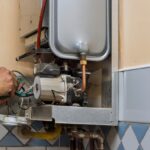 Technician repairing the internal components of a 40-Gallon Water Heater.
